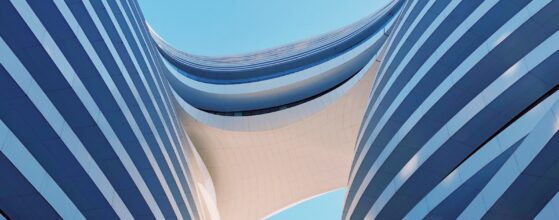 White modernist building with clean geometric angles against a clear sky