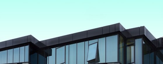 Gray and blue curtain wall building facade under blue sky