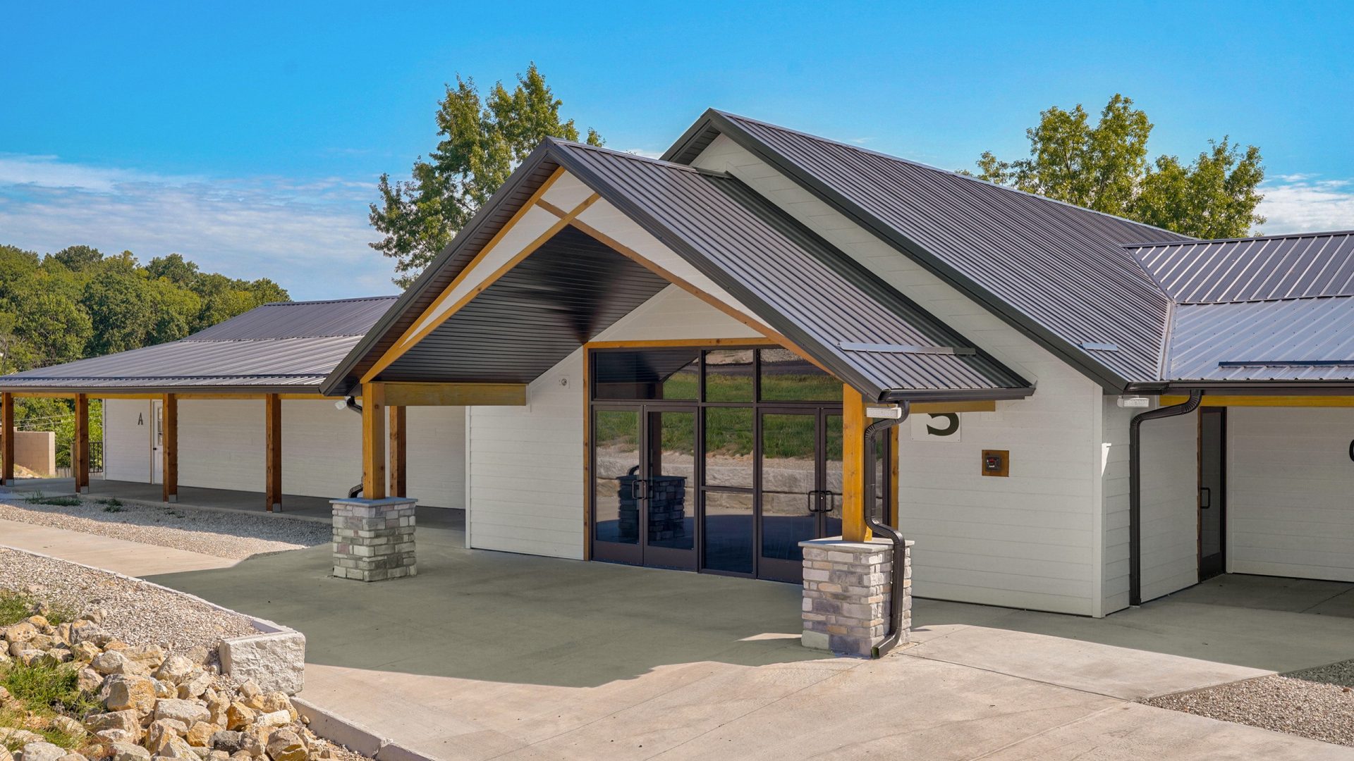 Exterior of Crosspointe Camp building in Rocky Mount, MO with covered gabled entry