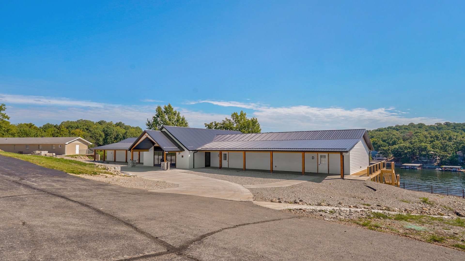 Exterior of Crosspointe Camp lakeside building in Rocky Mount, MO on a sunny day