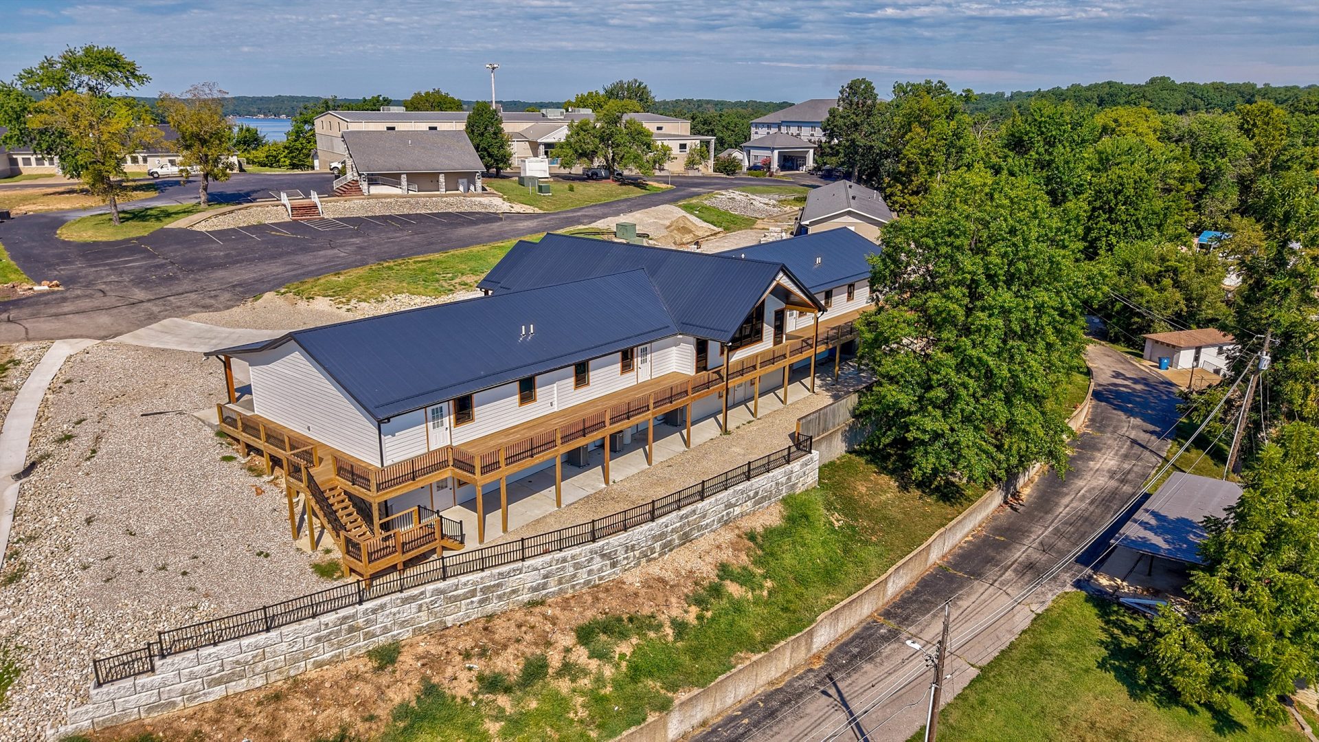 Aerial view of Crosspointe Camp lodge in Rocky Mount, MO with blue roof