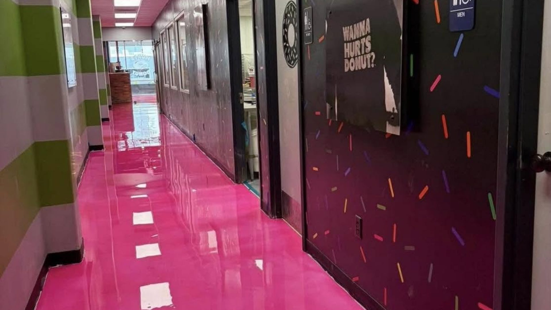 Pink epoxy floored hallway with sprinkle wall graphics inside Hurts Donut, Hot Springs, AR