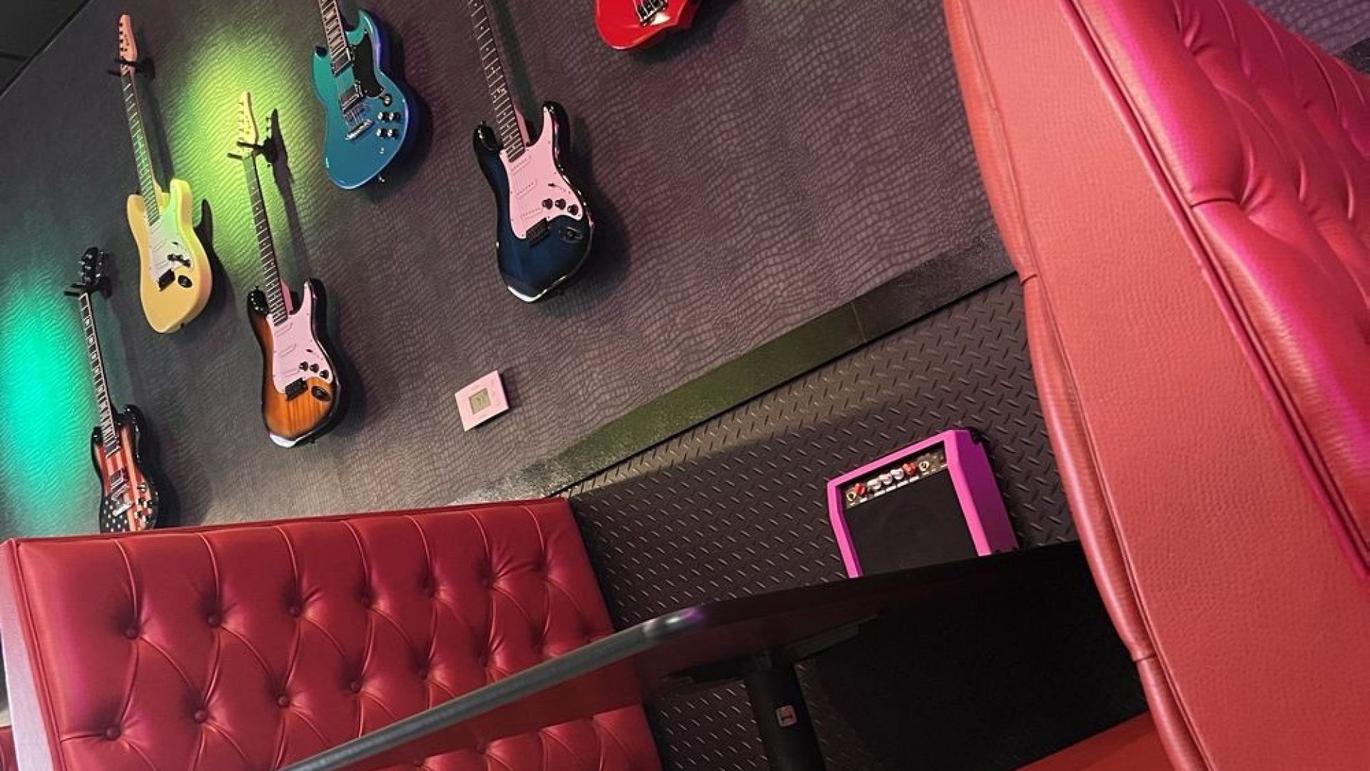 Interior of Rock N Roll Sushi in Mansfield, TX with red booths and guitars